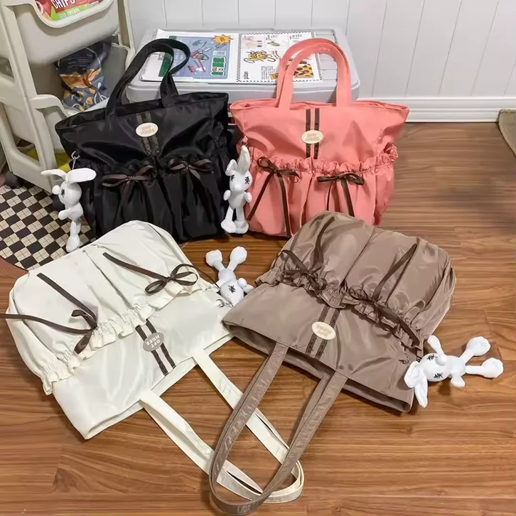 Lightweight Nylon Tote Bag with Bow Detail and Plush Charm product reference image