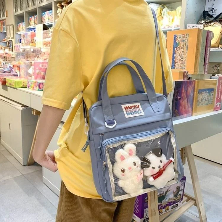 Nylon Crossbody Bag with Transparent Window and Doll Charms Blue color SKU reference