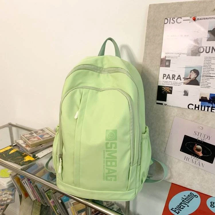 Nylon Student and Travel Backpack with Decorative Doll Charm Light green color SKU reference