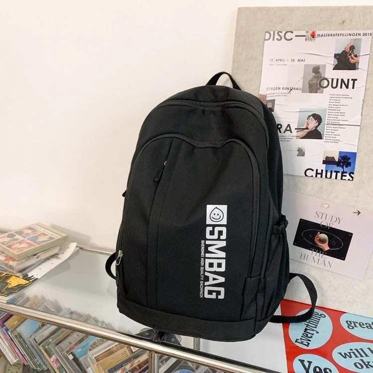 Nylon Student and Travel Backpack with Decorative Doll Charm Black color SKU reference